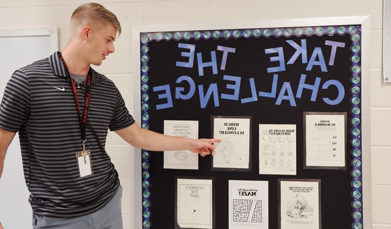 tyler kelley showing off a bulletin board